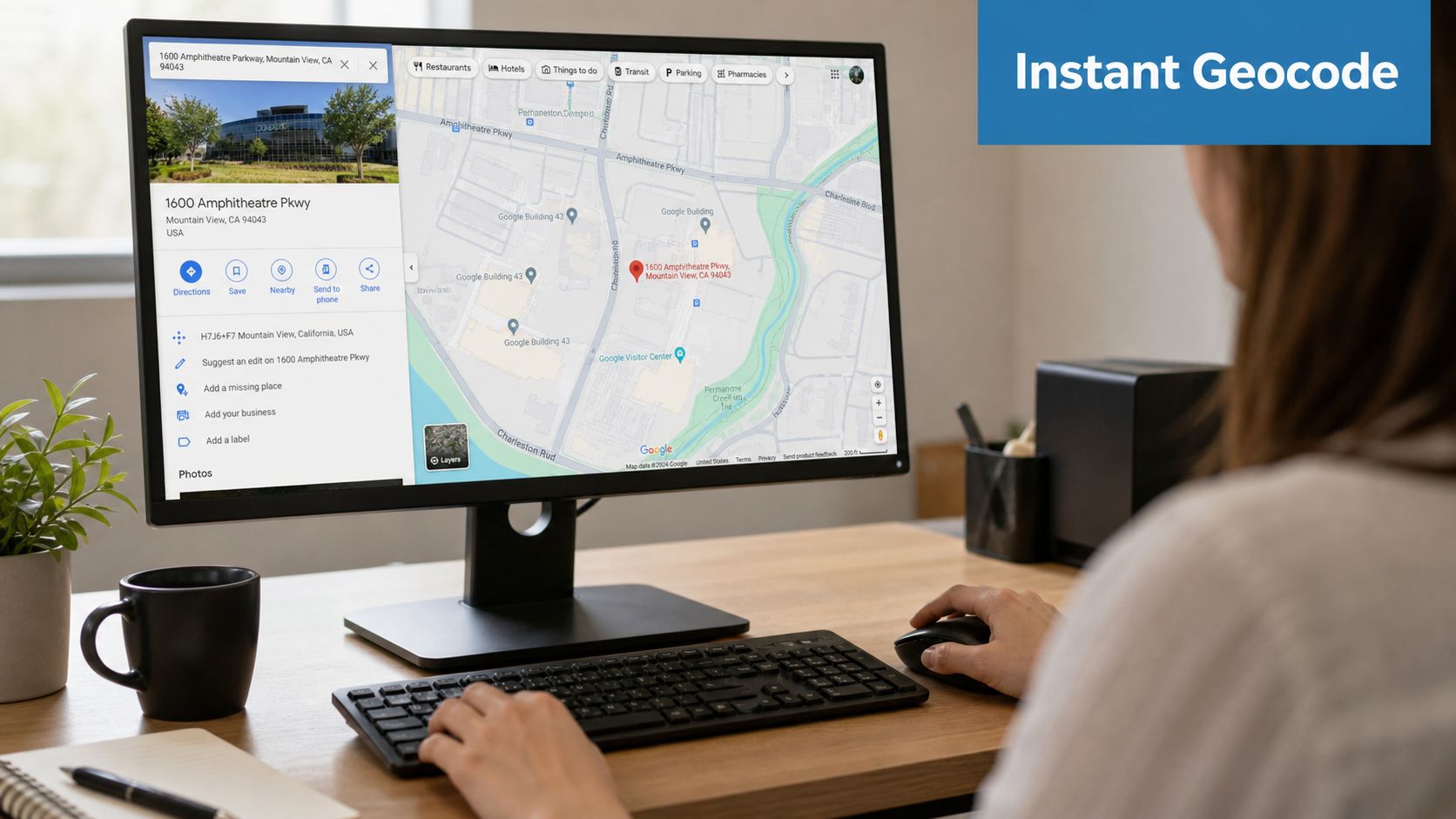 A person using a desktop computer to look up a specific address on Google Maps.