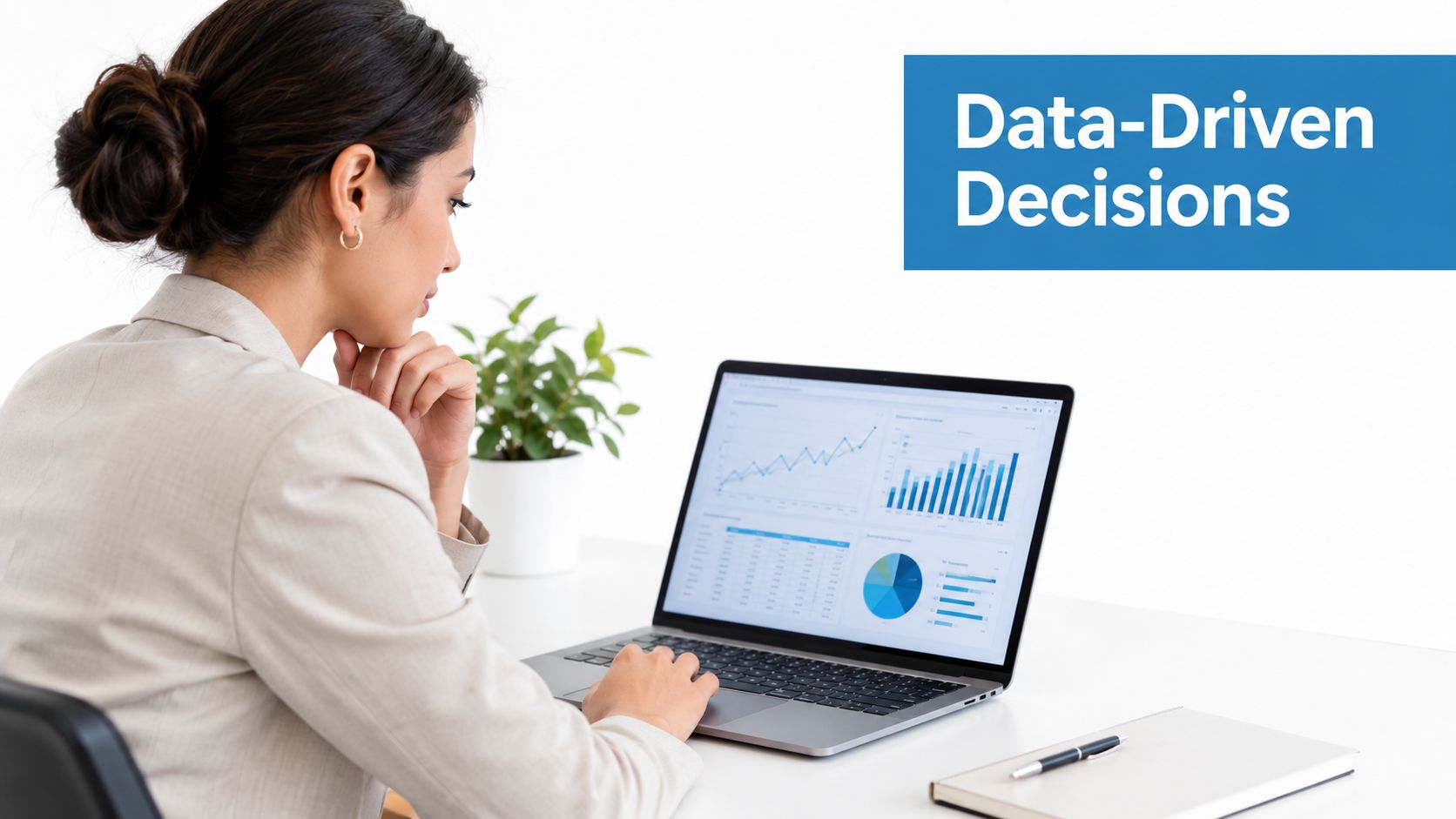 A professional woman in a suit analyzing business data charts on a laptop in an office.