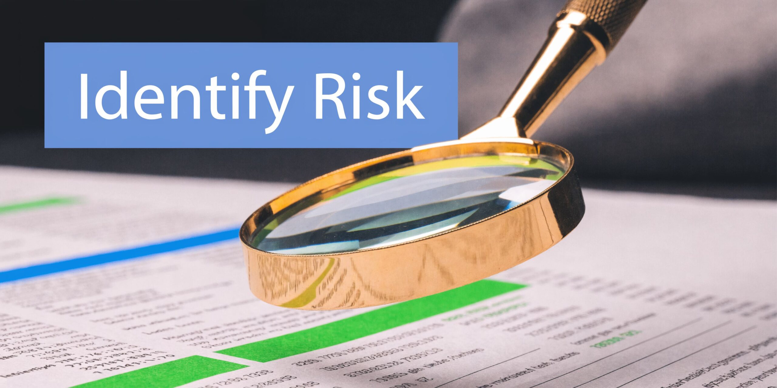 A magnifying glass positioned over a business document with the text Identify Risk in the background.