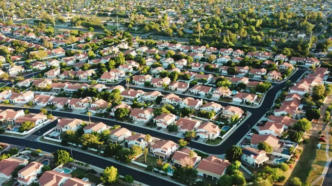 Drone view of a street of homes with seven numbered pins, each matched to a real estate industry